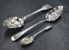 Three George III / IV silver berry spoons, two of fiddle pattern and one of Old English, all of