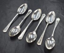 A set of six Edwardian silver teaspoons, having decorative engraving to the handle with vacant