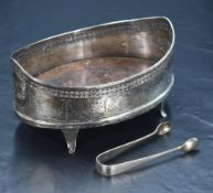 An Edwardian silver jardiniere, having pierced decoration, floral swag engraving and two cartouches,