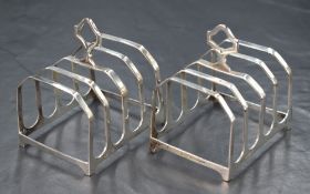 A pair of George V silver toast racks, of traditional form with pierced handles, marks for