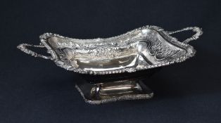 An impressive George III silver fruit bowl, of lobed rectangular form having an embossed floral