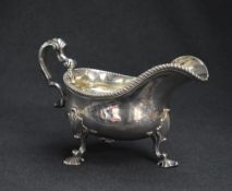 An impressive George III silver gravy boat, of traditional form having a gadrooned rim, narrow