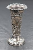 A Victorian silver vase, having a flared lobed rim, floral scroll diaper design body, with a