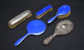 A George V blue guilloche and silver mounted vanity set, comprising a hair brush, a clothes brush,