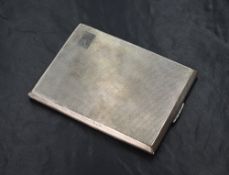 A George VI silver cigarette case of hinged rectangular form, having engine turned decoration and