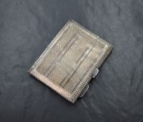 A George V silver cigarette case of hinged square form, having engine turned decoration and 'R.D.C