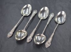 A group of five late Edwardian silver teaspoons, having twisted handles with decorative embossed