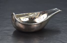 A George III silver sauce boat of round elongated form, having a narrow spout with raised back but