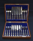 A 20th century Walker & Hall canteen, having a brass shield inlay containing a twelve piece silver