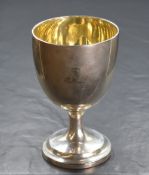 A Victorian silver cup, of traditional form having an engraved heraldic crest to the body, raised on