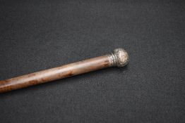 A Victorian silver mounted malacca walking cane, the wooden cane with rounded silver mounted top,