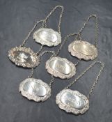 A group of six silver decanter labels, comprising Whisky, Gin, Rum, Brandy, Sherry and Port, all