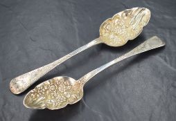 A pair of George IV silver berry spoons, of traditional form having embossed decoration to the