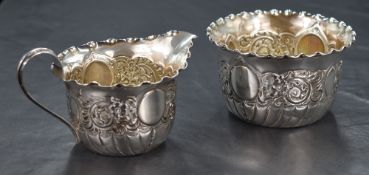 A Victorian silver sugar and cream of traditional form, both having crimped rims, and decorative