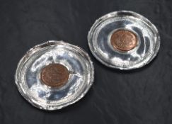 Two South Sudanese white metal dishes, each having decorative engraving to the base with a central