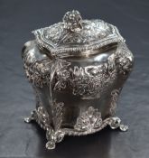 A late Victorian silver tea canister, of bulbous rectangular form, having a flower form finial,