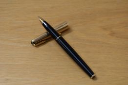 A Parker 65 Custom aerometric fill fountain pen in black with rolled gold cap having Parker 14k