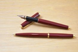 A Parker 75 cartridge/ converter fill fountain pen and ballpoint pen set in red having Parker 585