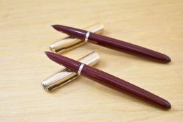 Two Parker 51 aerometric fountain pens in burgundy with rolled gold caps