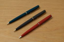 Three Parker 45 propelling pencils in red, green and grey two having gold clips