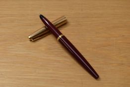 A Parker 45 converter fill fountain pen in red with gold fill cap