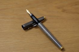 A boxed Parker 75 Cicele cartridge fill fountain pen in sterling silver with gold trim having Parker