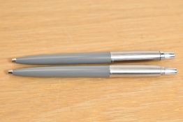 Two Parker Jotter ballpoint pens in grey (one missing clip)