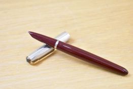 A Parker 51 aerometric fill fountain pen in burgundy with rolled silver cap with gold trim