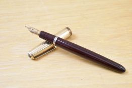 A Parker La Plume Lamine aerometric fill fountain pen in burgundy with rolled gold cap having Parker