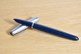 A Parker 51 plunger fill fountain pen in dark blue with twin jewel sterling silver cap. Dents to