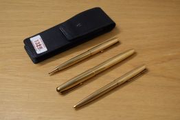 A Parker 51 consort aeromatic fill fountain pen, ballpoint pen, and propelling pencil in rolled