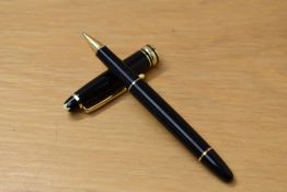 A Montblanc Meisterstuck Pix roller ball pen in black with gold trim