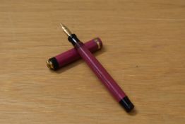A Parker Lucky Curve Lady button fill fountain pen in magenta with single band to ring top cap