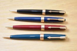 Four Parker 17 Super Duofold propelling pencils in black, red, blue, and green.