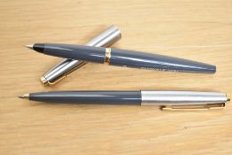 A Parker 45 converter fill fountain pen and ballpoint pen in grey having a lutraloy cap with gold