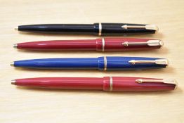 Four Parker 17 Jotter ballpoint pens in black, two red, and blue.