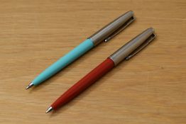 Two Parker 45 ballpoint pens one in baby blue the other terracotta