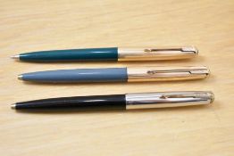 Three Parker 51 ballpoint pens a grey (engraved) a green (engraved) with rolled gold caps and a