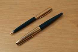 A Parker 45 converter fill fountain pen and propelling pencil set in green with gold fill caps