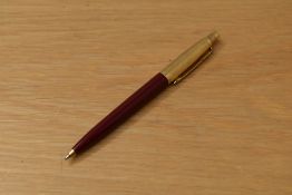 A Parker 45 ballpoint pen in red with gold reeded cap
