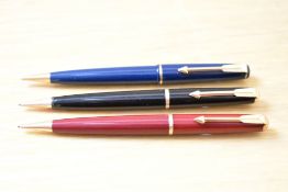 Three Parker 17 propelling pencils in black, red, and blue.