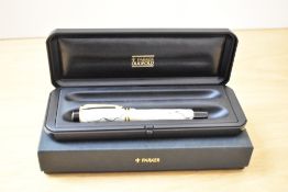 A boxed Parker Centenial MKII converter/Cartridge fill fountain pen in pearl and black with two