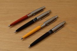 Four Parker Jotter ballpoint pens with perpetual calendars. In yellow, red and two black. one
