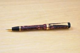 A Parker Centennial ballpoint pen in red marble.