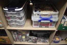 An assortment of crafting equipment and materials including flowers, ribbons etc.
