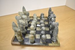 An interesting 20th Century East African design chess set, comprising thirty one soapstone carved