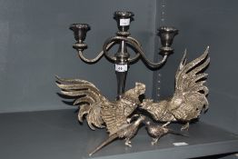 Two white metal fighting cockerel studies, the largest measures 19cm high, two pheasants, and a
