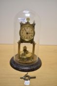 An early to mid 20th century brass 400 day torsion anniversary clock, under glass dome, having