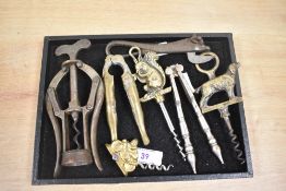 An early 20th Century cast iron cow form bottle opener, measuring 15cm long, and a selection of