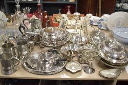 A large selection of silver plated ware comprising teapots, steins and a gravy boat etc.